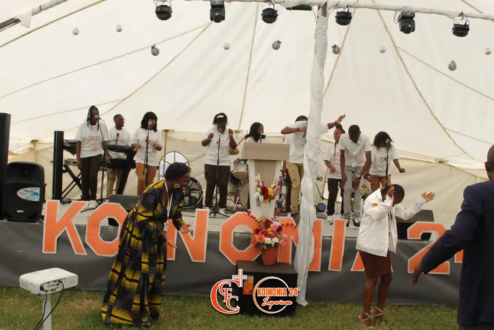 Dancing in front of the stage and the KOINONIA 24 letters