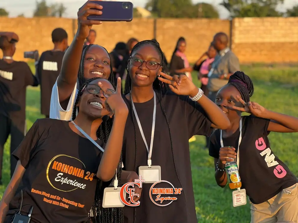 Young delegates taking a selfie in the evening sun